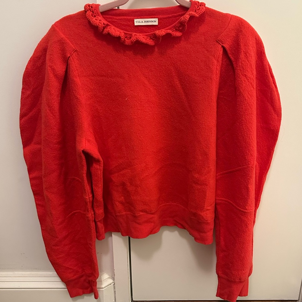 Red Ull’s Johnson sweater with buff shoulder and ruffle neckline. Size L